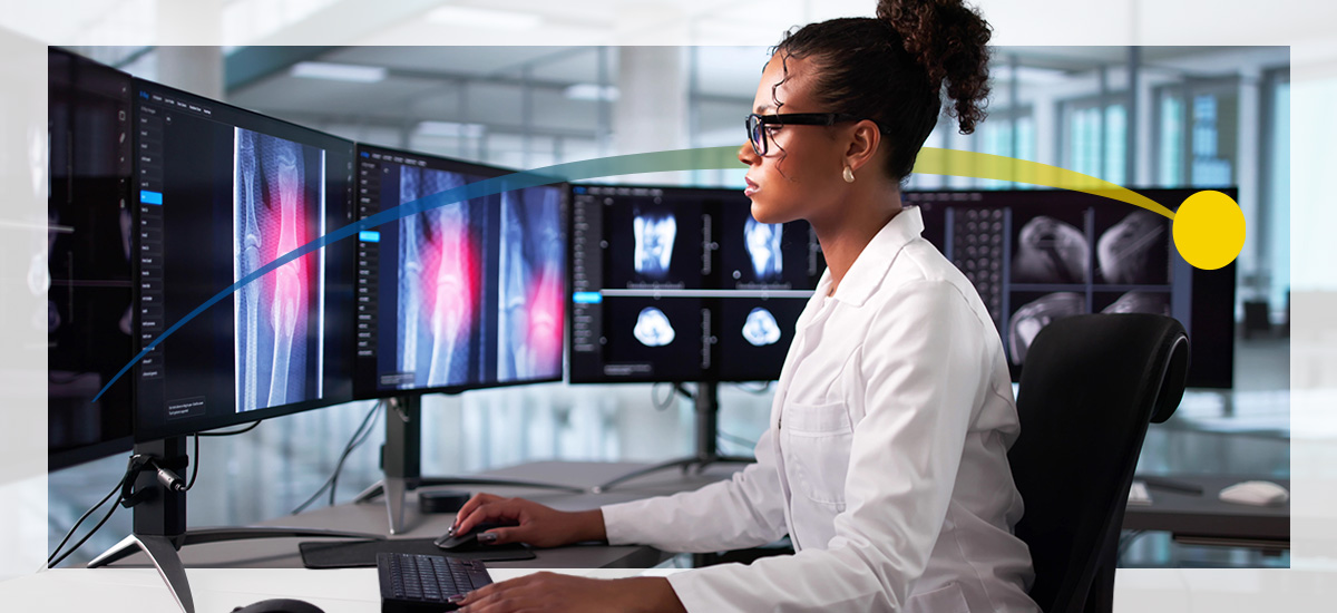 A woman wearing glasses review radiology images