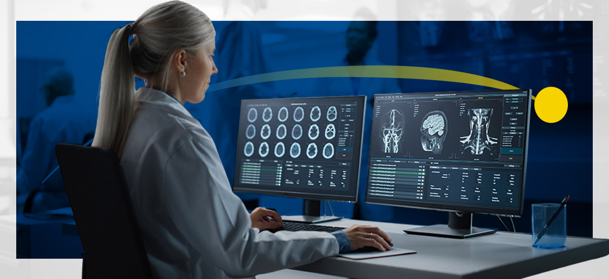 A radiologist reviews images on her workstation